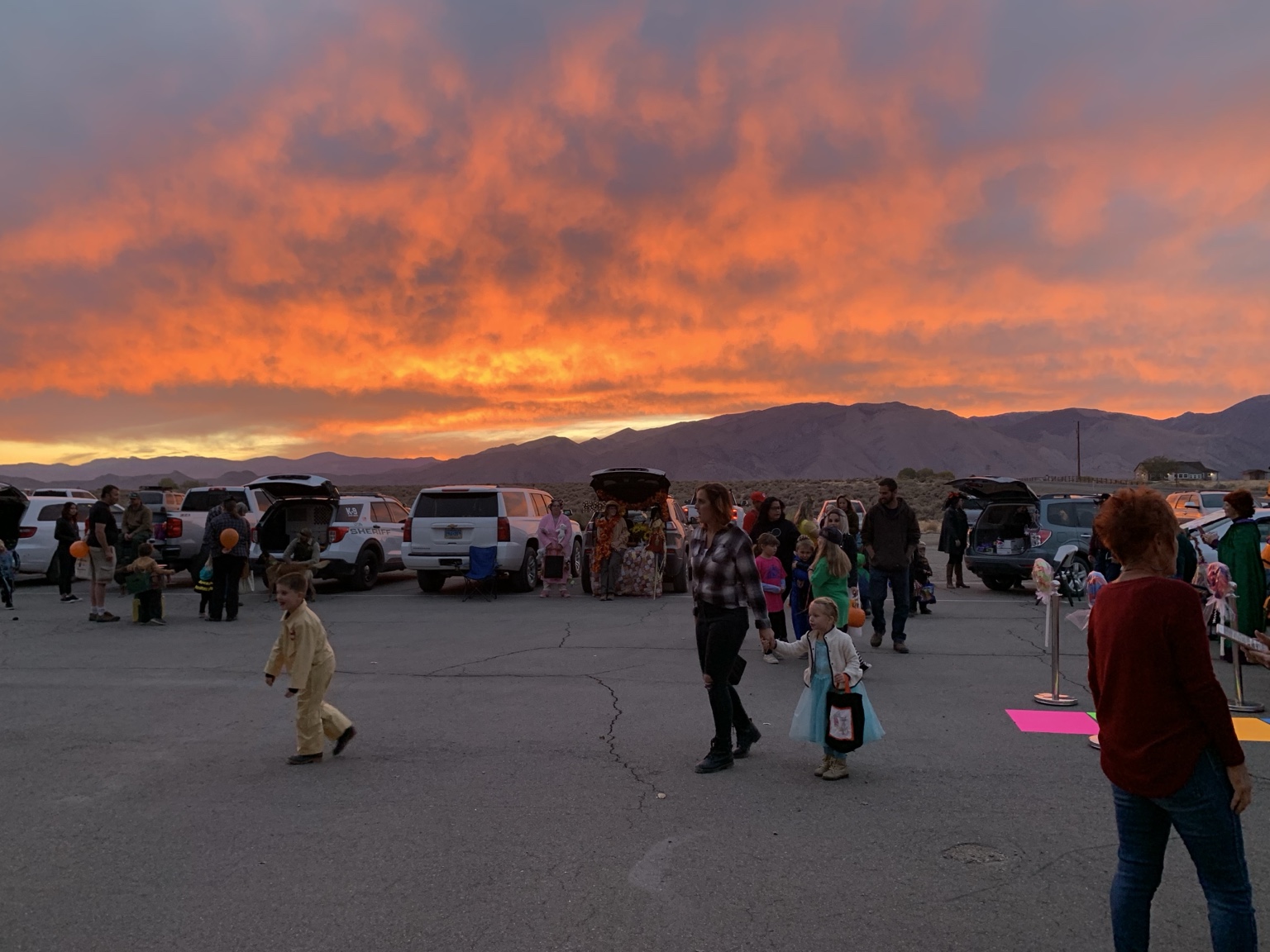 Families and costumed children enjoying a past Trunk or Treat at the fire station